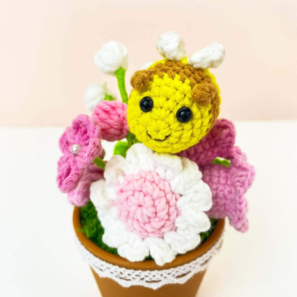 Close up of bee with flowers crochet pot