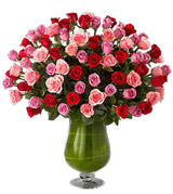 Heartfelt luxury flower arrangement in urn vase with assorted pink, lavender and red roses