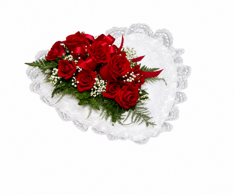 Red roses on satin heart for funeral service