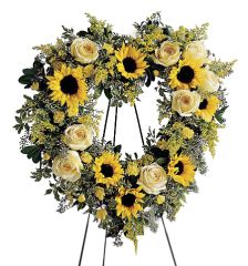 Funeral flower heart standing piece of all yellow flowers including sunflowers and roses