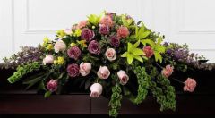 Forever beloved funeral casket spray with pink, purple and yellow flowers Large