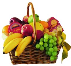Assorted seasonal fruit with cheese and crackers in a wicker basket