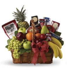 Assorted seasonal fresh fruit and gourmet food items in a basket