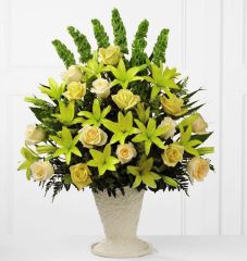 All yellow flowers in a one sided funeral flower arrangement Large
