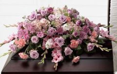 Immorata funeral flower casket spray of lavender roses, mums, tulips and carnations