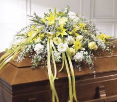 Casket spray of yellow and white assorted flowers for funeral