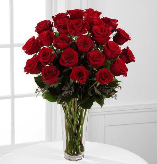 2 dozen fancy red roses arranged in glass vase