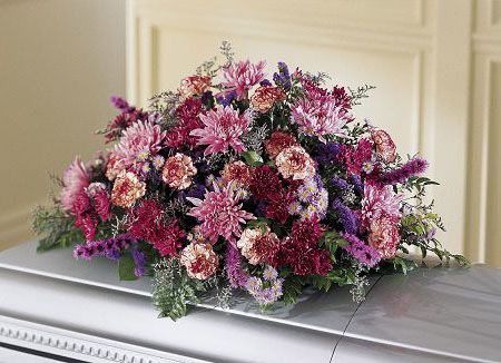 Casket spray of assorted pink flowers for funeral