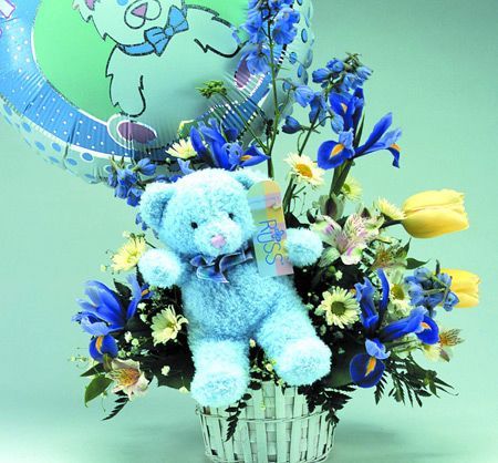 New baby flowers in basket with teddy bear and balloon