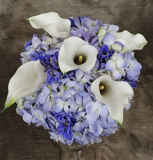 Blue hydrangea and white calla lilies in a clutch bouquet