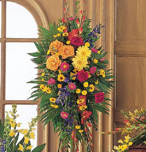 Celebration of Life funeral standing spray of vibrant flowers