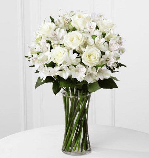 All white fresh flowers arranged in a gathering vase Small