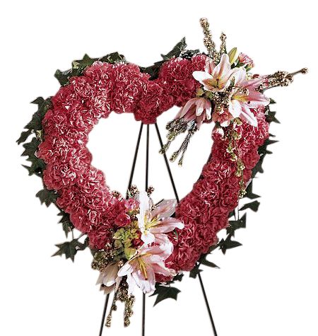 Funeral flower heart standing spray of pink carnations with stargazer lilies