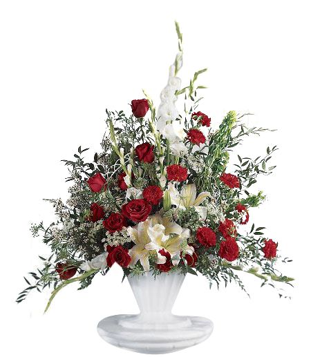 One sided funeral flower arrangement with red and white flowers