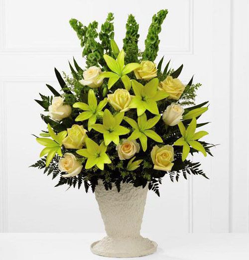 All yellow flowers in a one sided funeral flower arrangement Small