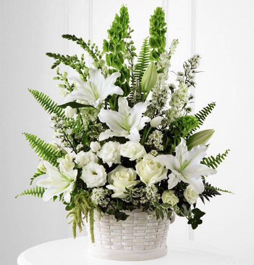 In Our Thoughts funeral flower arrangement of assorted white and green flowers in a white basket Small