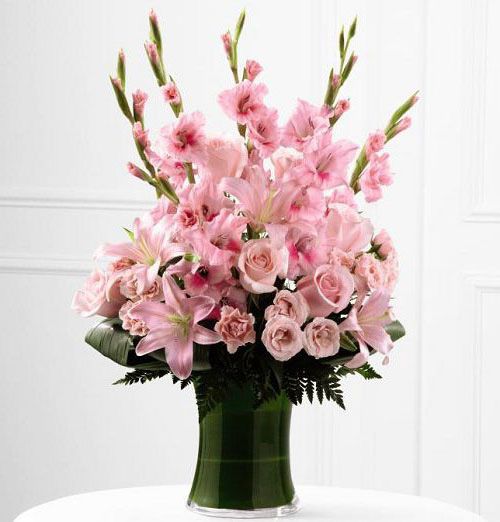 Gathering vase of blooming gladiolus for sympathy Small
