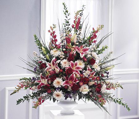 One sided funeral flower arrangement of peaceful pinks