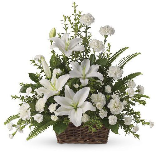 One sided basket arrangement of assorted white lilies and mini carnations for sympathy