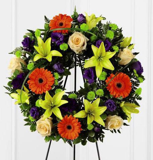 Radiant remembrance funeral flower wreath with bright flowers