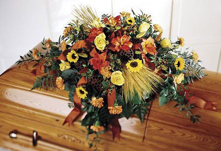 Fall flower casket spray with yellows, oranges and rust flowers
