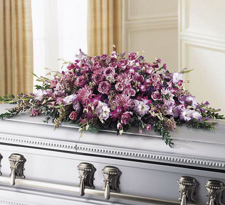 Casket spray of lavender roses and orchids for funeral