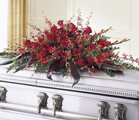 Casket spray of assorted red roses and orchids for funeral
