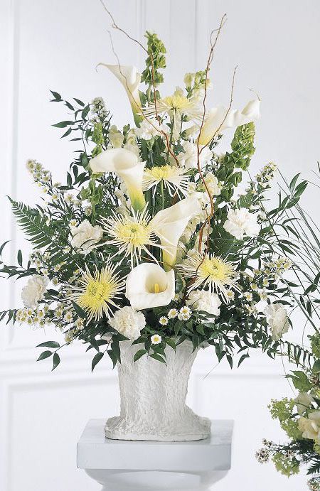 One sided funeral flower arrangement with white calla lilies and spider mums