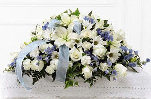 Tender treasure funeral flower casket spray of pale blue and white flowers for baby boy