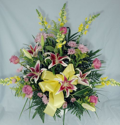 Traditional funeral flower mache of stargazer lilies, stock and roses