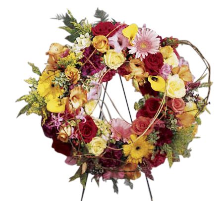 Vibrant friendship funeral flower wreath with bright roses, gerbera daisies and calla lilies