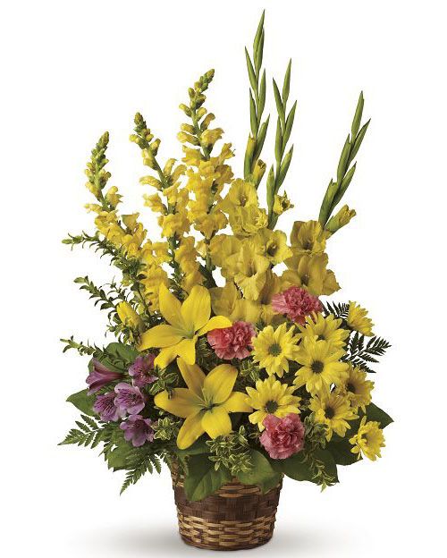 Vivid recollections bouquet of yellow lilies, mums and gladiola in wicker basket