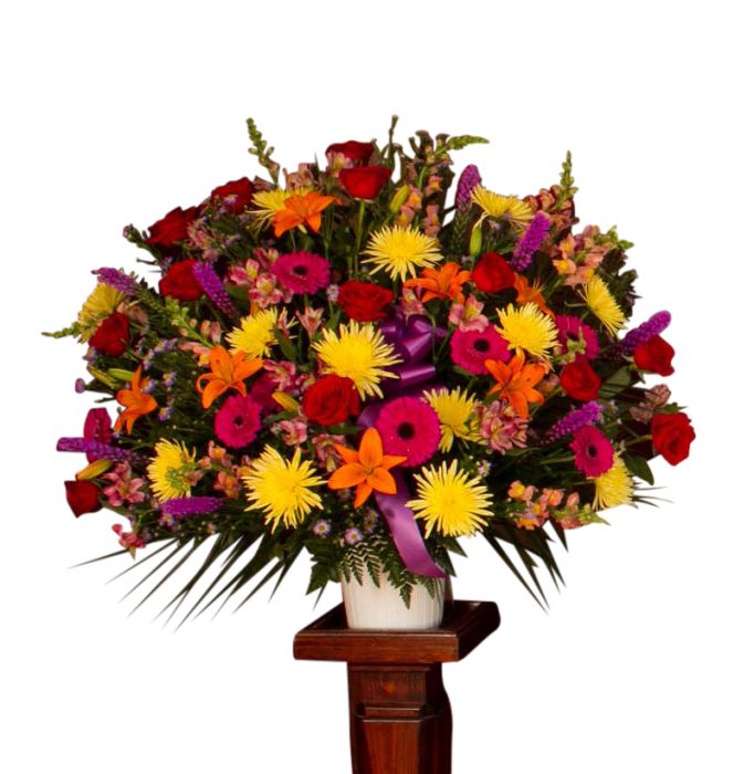 Garden floral funeral basket with red, yellow, orange and pink flowers