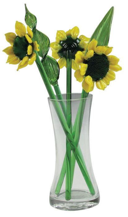 Glass sunflowers and greens in a glass vase