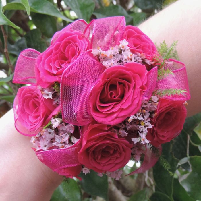 Hot pink rose corsage on wrist