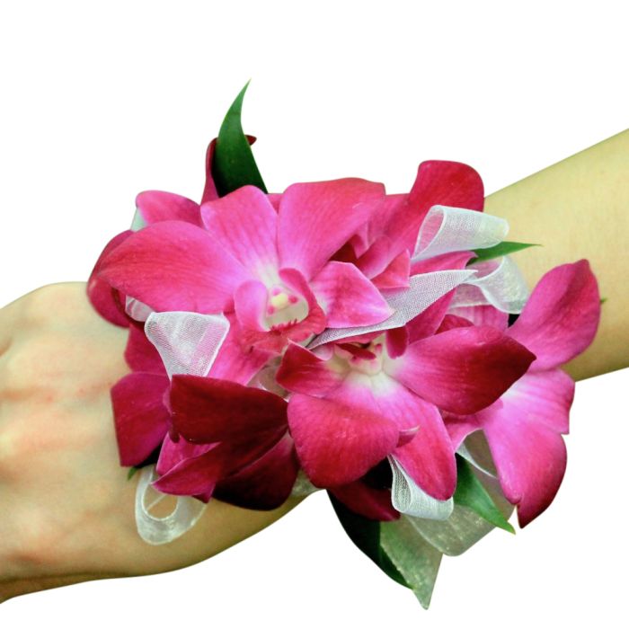 Purple orchid corsage on wrist